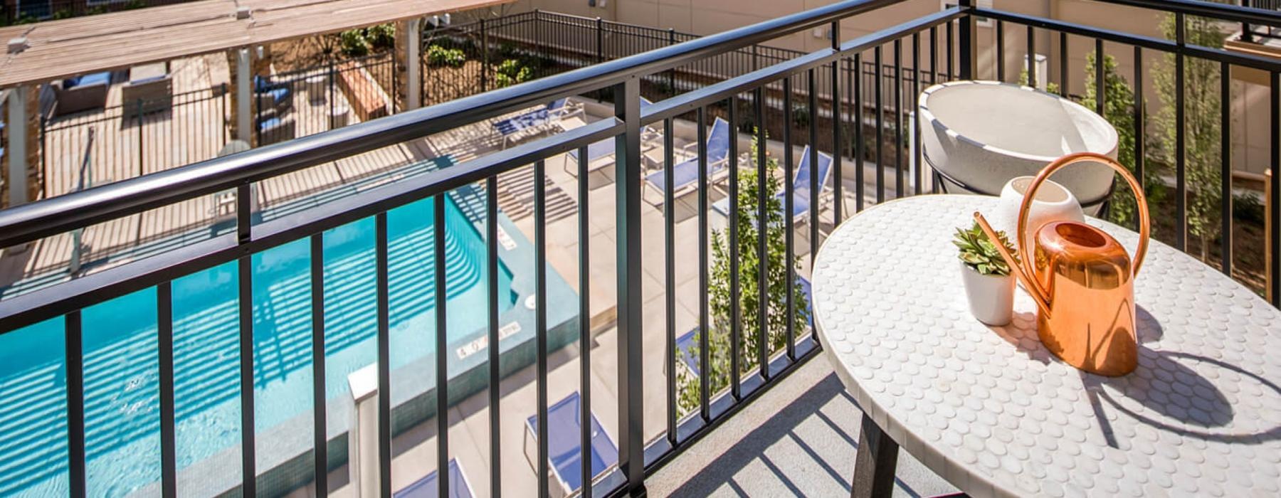 a deck with a table and chairs and a potted plant on it