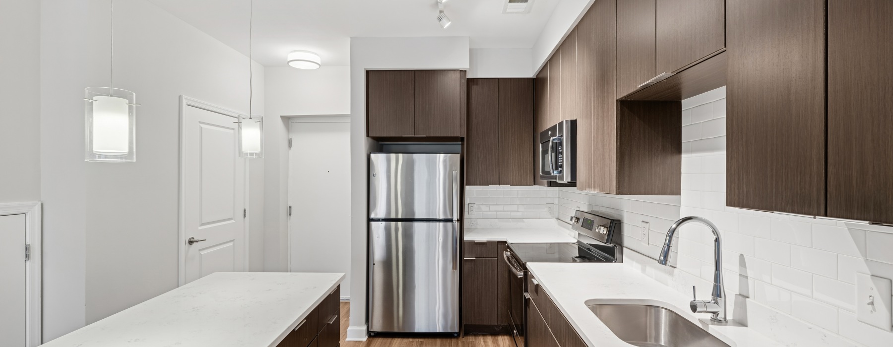 Kitchen with white countertops and brown cabinets